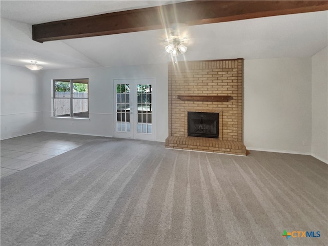 unfurnished living room with carpet, a fireplace, ceiling fan, and vaulted ceiling with beams