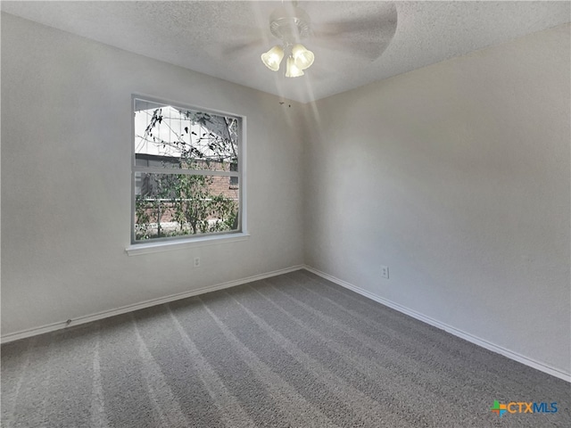 carpeted empty room featuring ceiling fan and a textured ceiling