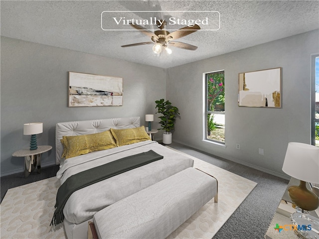 carpeted bedroom with a textured ceiling and ceiling fan