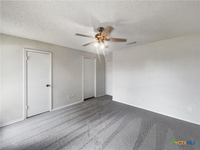 1009 N 4th St, Copperas Cove, TX 76522 - unfurnished bedroom featuring carpet floors, a textured ceiling, baseboards, multiple closets, and a ceiling fan