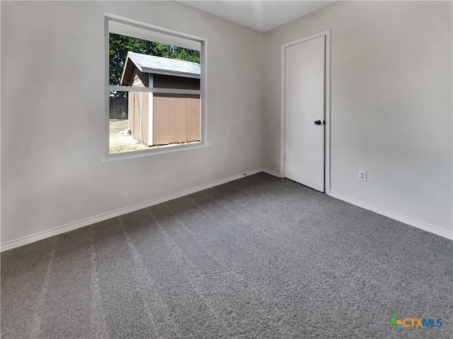 carpeted spare room with a wealth of natural light