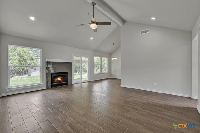 102 Montague Dr, Kyle, TX 78640 - unfurnished living room with a ceiling fan, beam ceiling, a warm lit fireplace, baseboards, and high vaulted ceiling