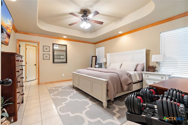 bedroom featuring baseboards, a raised ceiling, ceiling fan, crown molding, and light tile patterned flooring