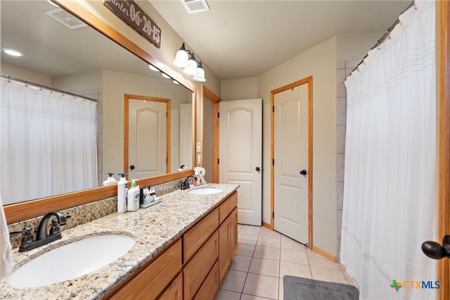 full bath with visible vents, a sink, and tile patterned floors