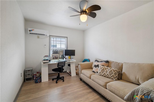 office featuring a ceiling fan, baseboards, a wall mounted air conditioner, and wood finished floors