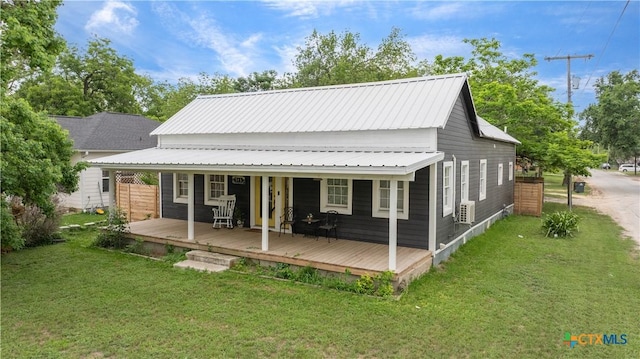 back of house with a yard and metal roof