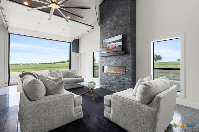 295 Honey Bee Ln, Rogers, TX 76569 - living area featuring baseboards, a ceiling fan, a high ceiling, and a fireplace