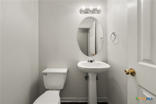 bathroom with toilet and sink