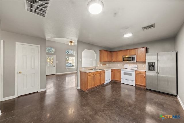 kitchen featuring sink, ceiling fan, a textured ceiling, tasteful backsplash, and stainless steel appliances