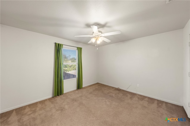 carpeted spare room featuring ceiling fan