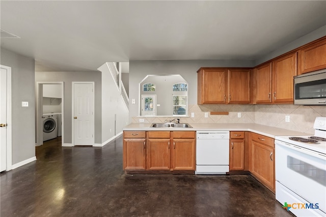 kitchen with white appliances, washer / clothes dryer, tasteful backsplash, and sink