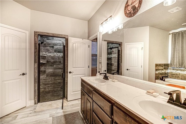 bathroom featuring independent shower and bath, vanity, and hardwood / wood-style flooring