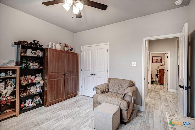 sitting room featuring ceiling fan and light hardwood / wood-style floors