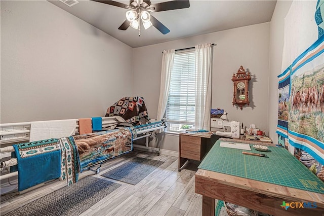 rec room with ceiling fan and light hardwood / wood-style flooring