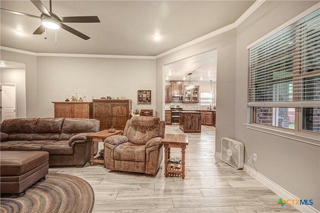 living room with crown molding, ceiling fan, and light hardwood / wood-style floors