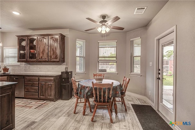 dining room with ceiling fan and light hardwood / wood-style flooring