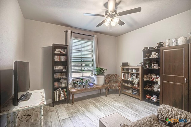 sitting room featuring ceiling fan and light hardwood / wood-style flooring