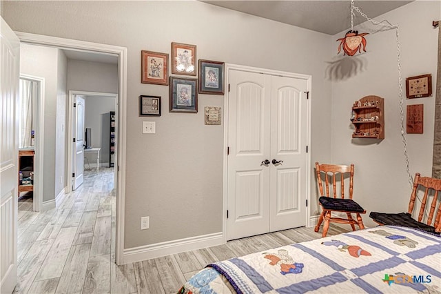 bedroom featuring light hardwood / wood-style floors and a closet