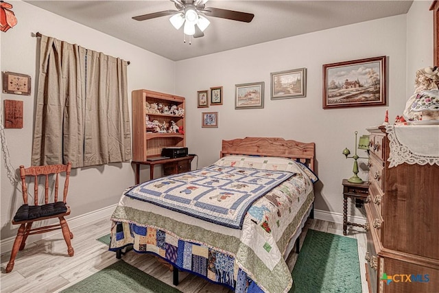 bedroom featuring hardwood / wood-style floors and ceiling fan