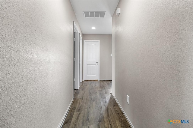 210 Mancos Dr, Georgetown, TX 78626 - hallway with wood finished floors, a textured wall, and recessed lighting