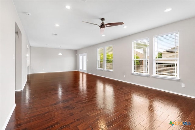 210 Mancos Dr, Georgetown, TX 78626 - unfurnished room with ceiling fan, wood finished floors, recessed lighting, and arched walkways