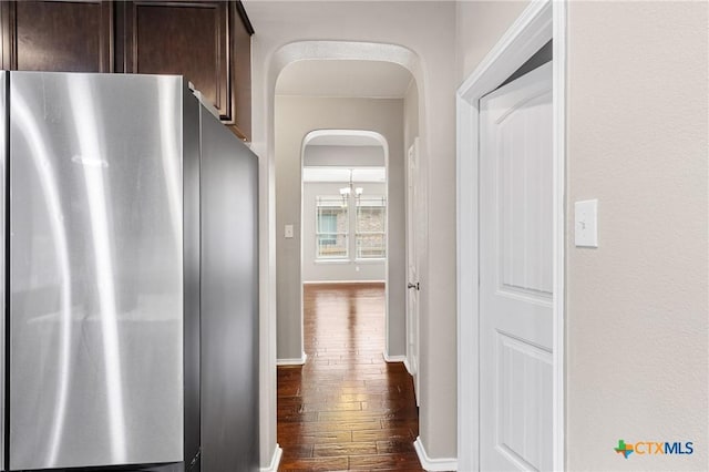 210 Mancos Dr, Georgetown, TX 78626 - hall with arched walkways and dark wood finished floors