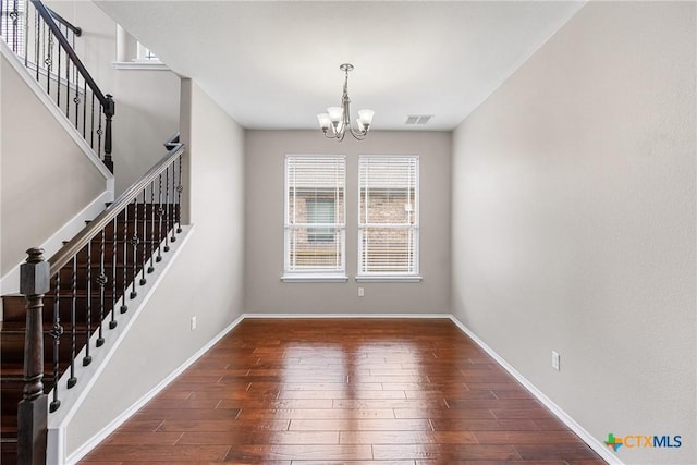 210 Mancos Dr, Georgetown, TX 78626 - unfurnished room with a chandelier, healthy amount of natural light, and hardwood / wood-style flooring
