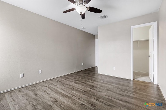 210 Mancos Dr, Georgetown, TX 78626 - unfurnished bedroom featuring wood finished floors, a walk in closet, ceiling fan, and a closet
