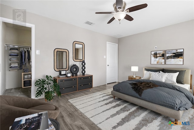 210 Mancos Dr, Georgetown, TX 78626 - bedroom with wood finished floors, ceiling fan, a walk in closet, and a closet