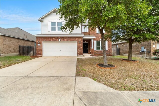 210 Mancos Dr, Georgetown, TX 78626 - view of front of property with an attached garage, brick siding, and driveway
