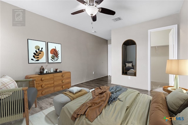 210 Mancos Dr, Georgetown, TX 78626 - bedroom with wood finished floors, a walk in closet, ceiling fan, and a closet
