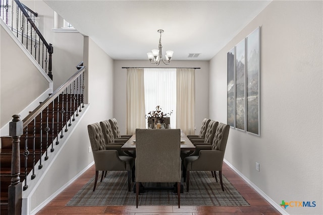 210 Mancos Dr, Georgetown, TX 78626 - dining area featuring a chandelier, wood finished floors, and stairway