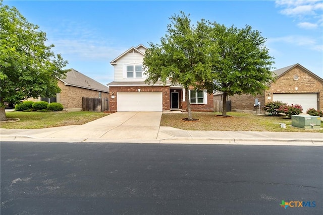 210 Mancos Dr, Georgetown, TX 78626 - view of front facade with brick siding, driveway, and a garage