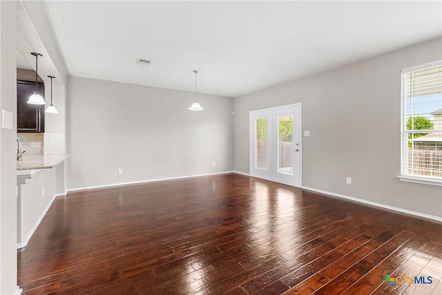 210 Mancos Dr, Georgetown, TX 78626 - unfurnished living room featuring dark wood finished floors and french doors
