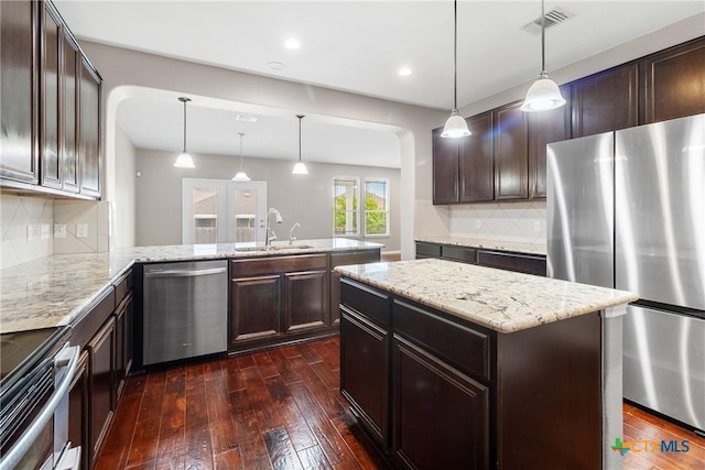 210 Mancos Dr, Georgetown, TX 78626 - kitchen with stainless steel appliances, dark wood-type flooring, dark brown cabinets, and recessed lighting