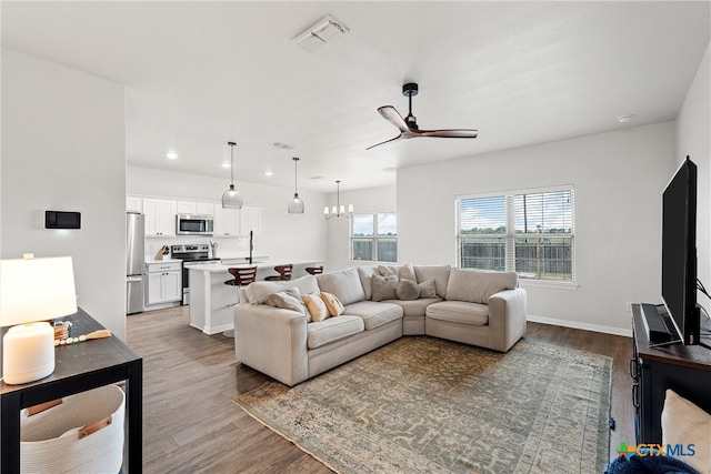 living room featuring dark hardwood / wood-style flooring and ceiling fan