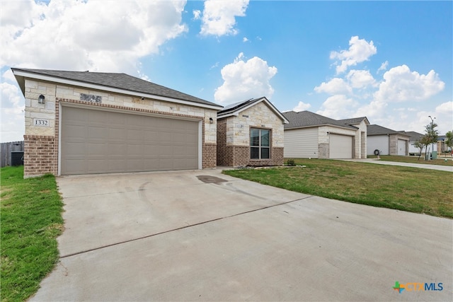 view of front facade featuring a garage and a front lawn