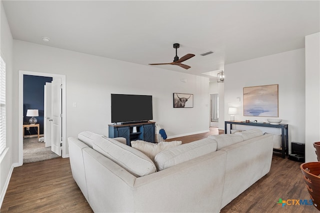 living room with ceiling fan and dark hardwood / wood-style floors