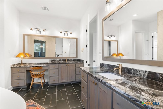 bathroom with a sink, visible vents, two vanities, and tile patterned floors