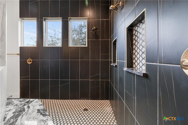 bathroom featuring a tile shower