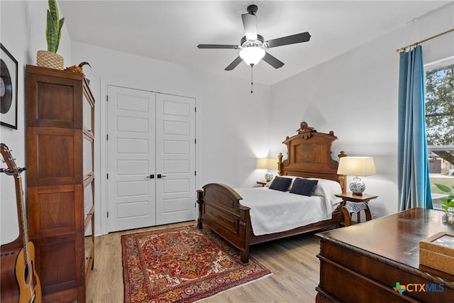 bedroom featuring a closet, a ceiling fan, and light wood-style floors