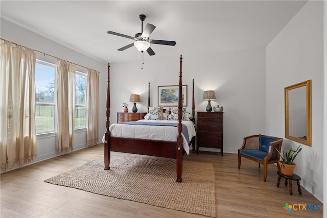 bedroom with wood finished floors, baseboards, and ceiling fan