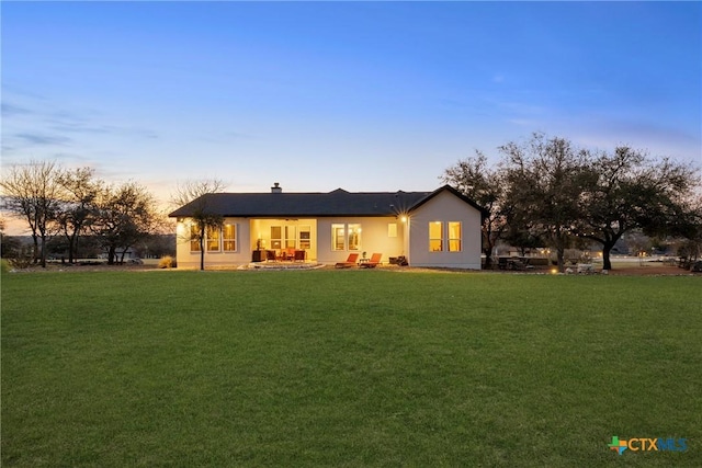 back of house featuring a yard