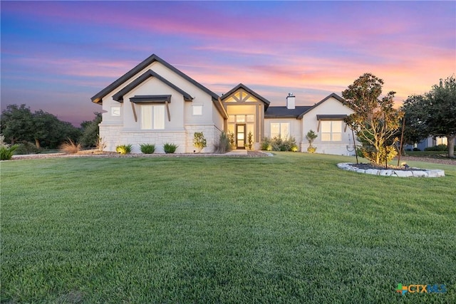 modern farmhouse with a front lawn and stucco siding