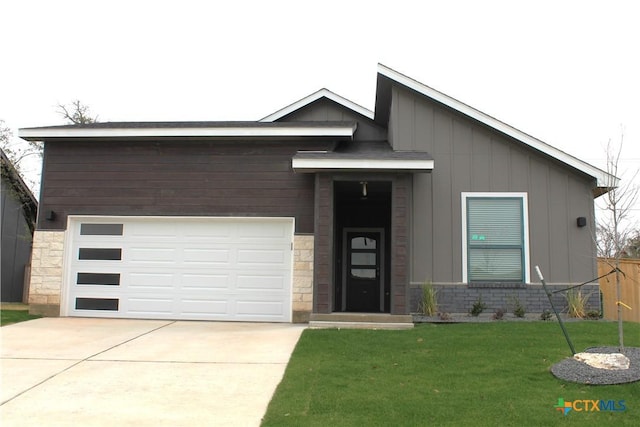 view of front of home featuring a garage and a front lawn