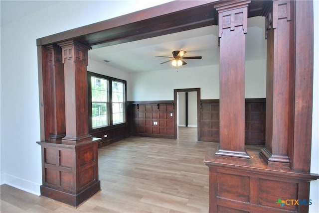 215 E Gonzales St, Yoakum, TX 77995 - unfurnished living room featuring a ceiling fan, light wood-style flooring, and ornate columns