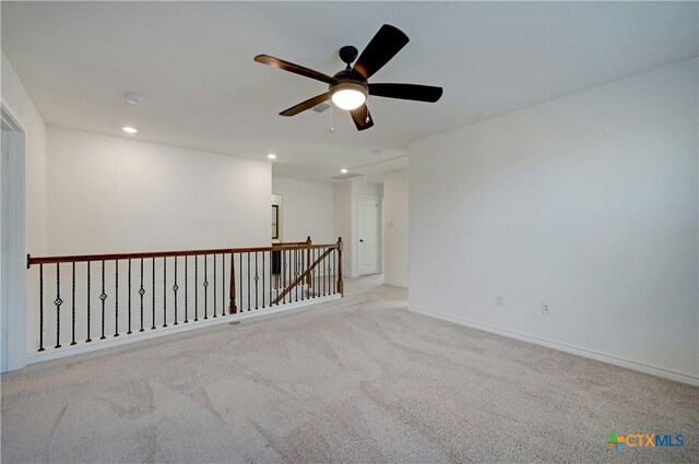 carpeted spare room with ceiling fan