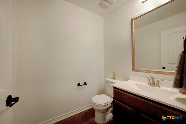 bathroom featuring vanity, toilet, and wood-type flooring