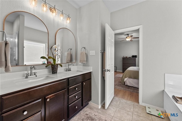 ensuite bathroom with tile patterned floors, double vanity, a sink, and ensuite bathroom