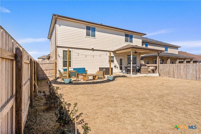 rear view of property with a patio area and a fenced backyard